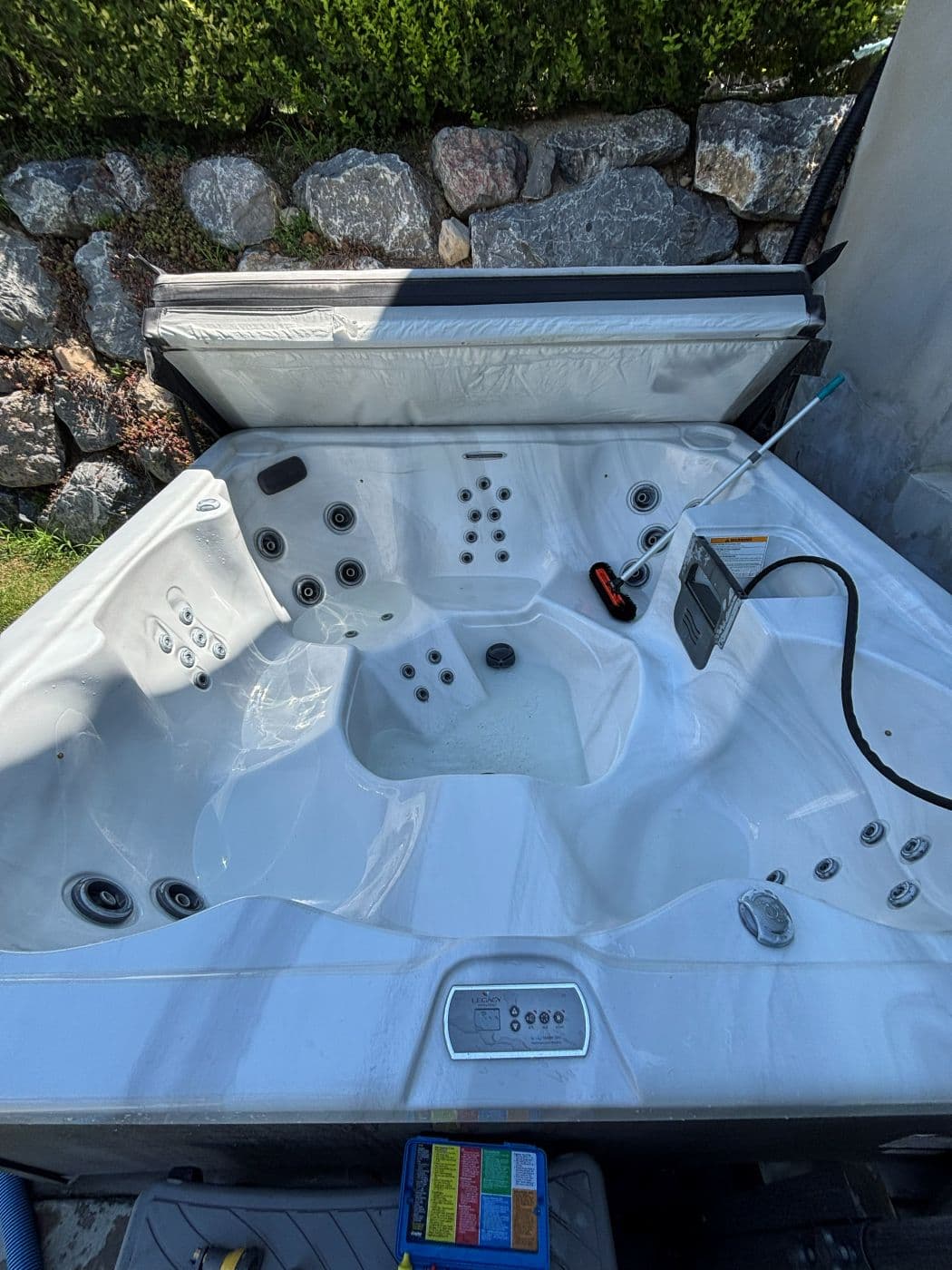 The same hot tub empty and being scrubbed out