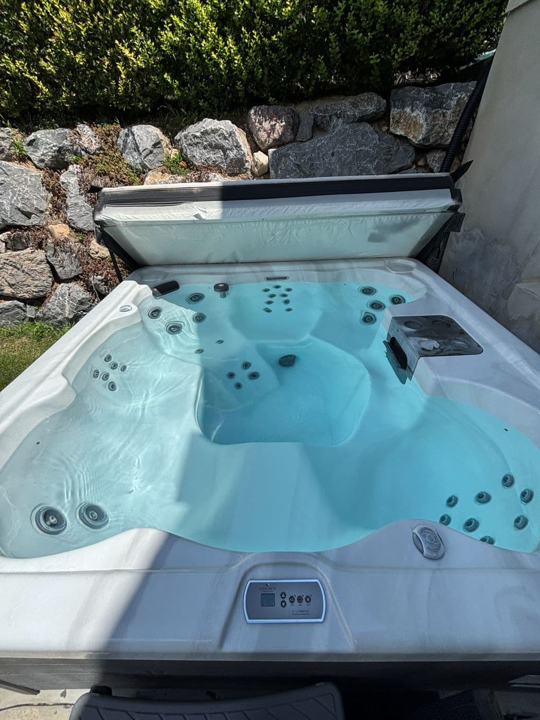 The same hot tub refilled with clear water and the jets running