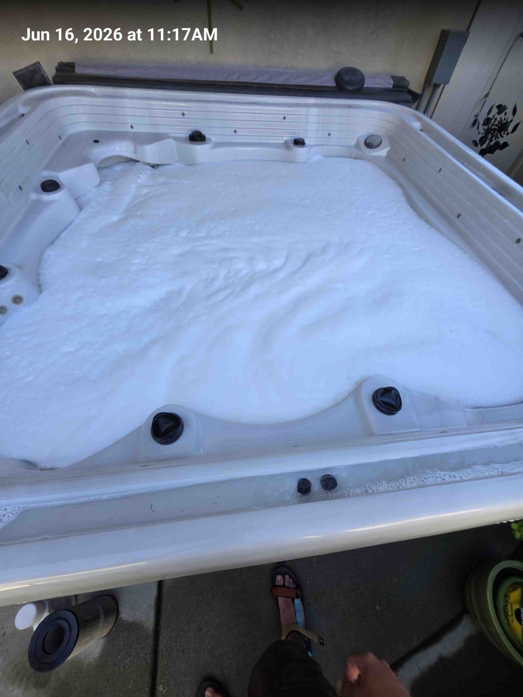 Hot tub filled with white foam and suds