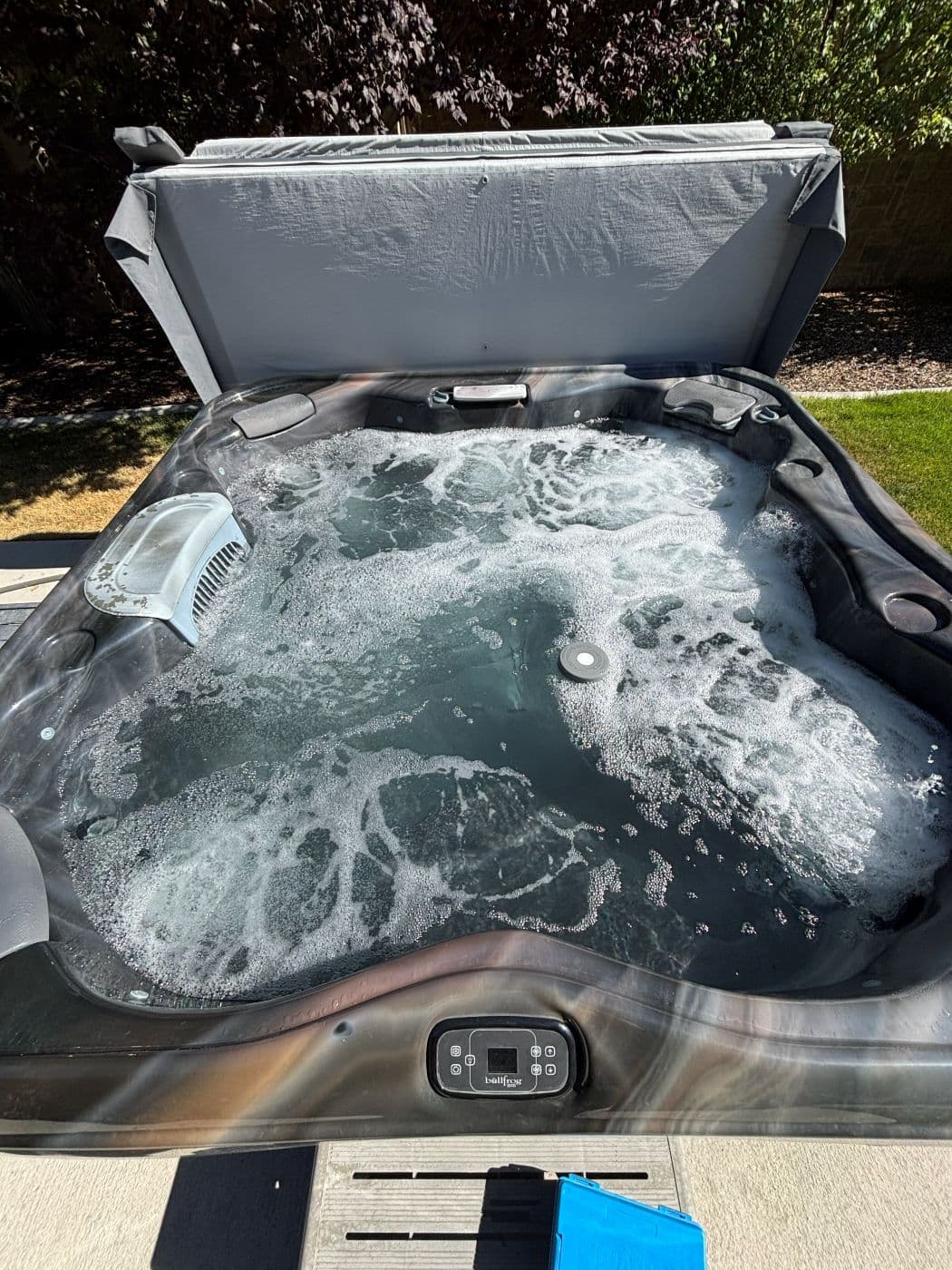Hot tub with the cover open full of white foam