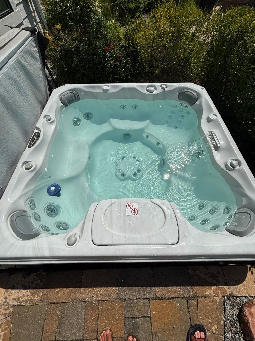 Overhead view of a hot tub with clear water and the jets running