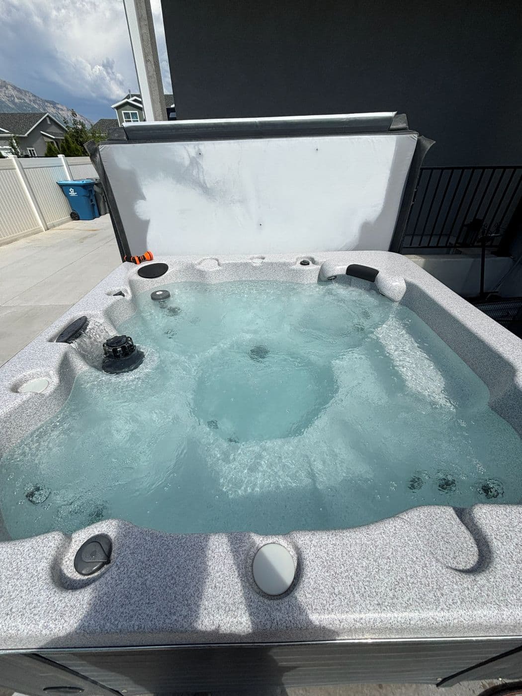 The same hot tub with clean clear water after a drain, clean and refill
