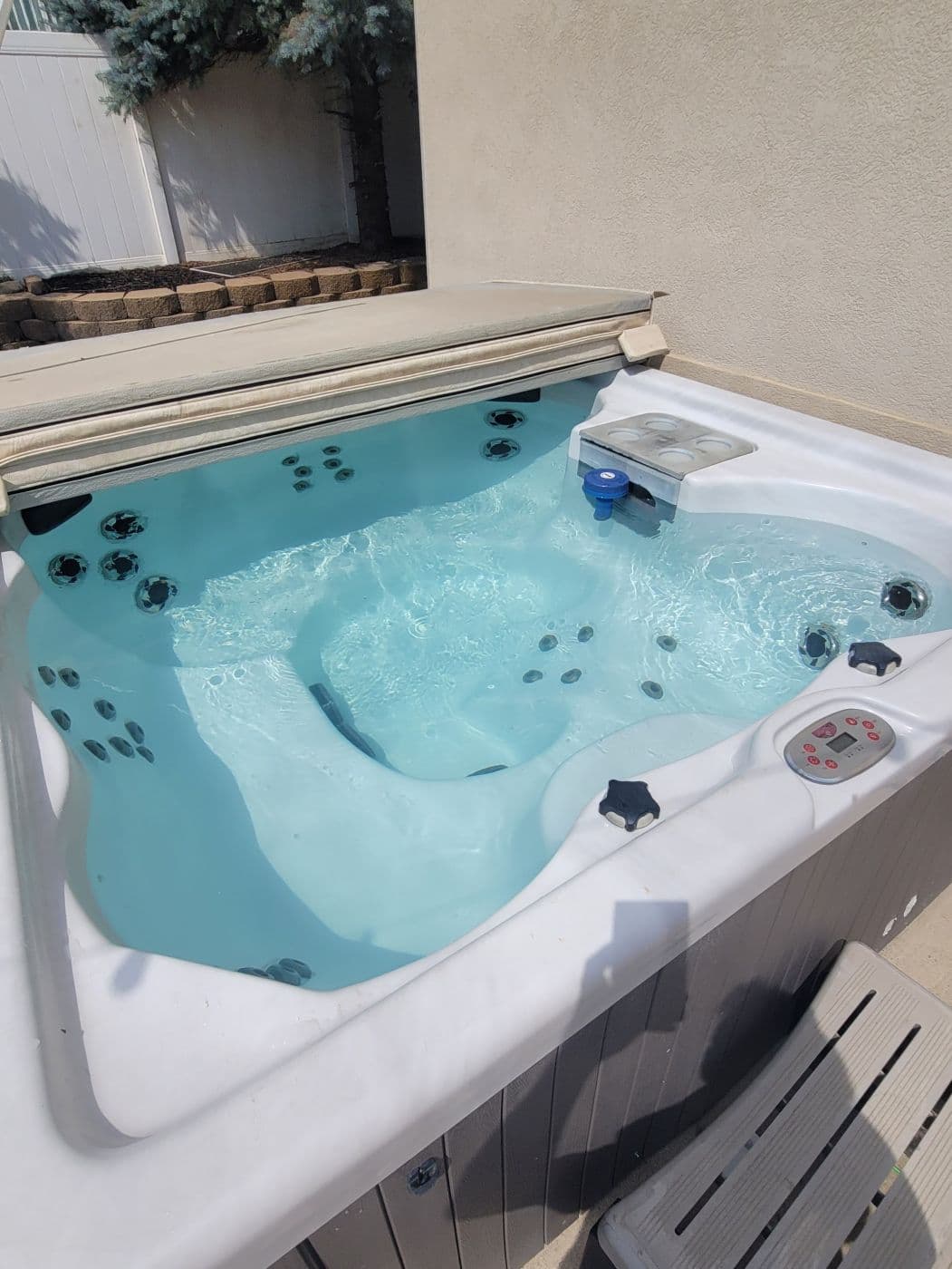 Hot tub with clear water and the jets running with the cover open